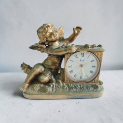A gilded cherub mantel clock 