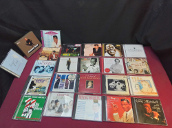 A collection of 25 UK music CDs including Louis Armstrong, Dean Martin, Nat King Cole and Frank Sinatra 