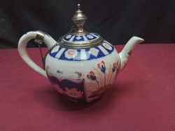 A vintage Sadler teapot made in England, decorated with a traditional blue, white, and red Imari pattern with 925 Silver Rim and Stamped to base. W.20 H.16 Cm.