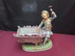 A German bisque porcelain figural planter, likely from the late 19th or early 20th century stamped to base. W.15 L.25 H.28 Cm.