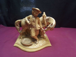 An antique Eichwald #2624 majolica pipe holder/vesta striker figure of young man and horse. W.15 L.21 H.19 Cm.
