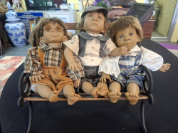 Vintage Gi-Go Dolls impressive faces collections sat on a bences