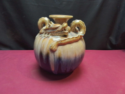 A Chinese ceramic vase featuring a distinctive drip glaze technique with blue, brown, and cream colors with 3 dimensional dragon relief.  W.18 H.21 Cm.