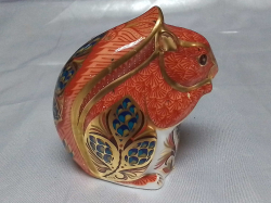 A Royal Crown Derby Paper Weight with a Silver Stopper Modeled as a   Squiral. W.9 H.10 Cm.
