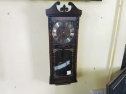 An Acctim 30 day Wall Clock with Pendulum and Key mechanical movement. W.26 H.75 Cm.