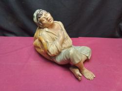 A Heavy Sculpture of man in the basket.W.19 L.33 H.22 Cm.