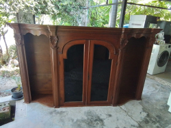 A handcrafted wood cabinet featuring detailed floral carvings and curved glass doors. W.225 D.45  H.130 Cm.