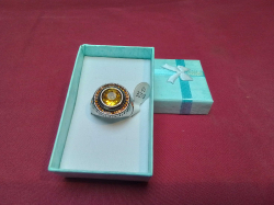 A silver plated yellow gemstone ring