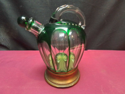 A vintage Bohemian or Saint-Louis green overlay cut crystal decanter featuring a signature cut-glass pattern. H.20 W.18 Cm.