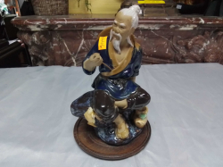 A Chinese Mudman Figure of a Fisherman W.12 H.19 Cm.