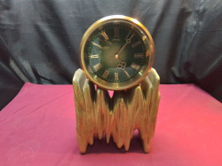 A Heavy Electric battery clock on a Matal base.