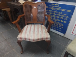 A cane back armchair on Queen Ann legs
