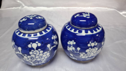 A pair of Chinese blue & white prunus pattern ginger jars with lids with double concentric blue marks to base. 12 cm high