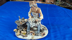 A very elaborate capodimonte porcelain group of a cobbler repairing a shoe signed 
