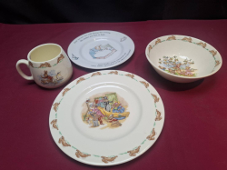 A rare three piece set of Royal doulton peter rabbit ceramics a plate,bowl and cup. Along with a wedgewood peter rabbit plate