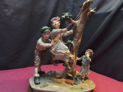 A Large Ceramic  Figure of Children playing of a base

H.14
W.9
