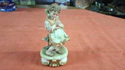 A Nice porcelain Capodimonte figure of a young girl signed by Artis. W.10 cm H.21 cm