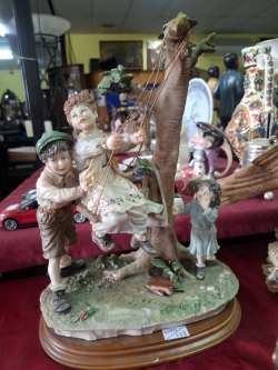 A Large Ceramic  Figure of Children playing of a base

H.14
W.9
