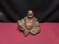 Laughing happy budha/hotei sat holding prayer beads Auspicious Chinese symbols on the robs 
H.13cm.
W.17cm.