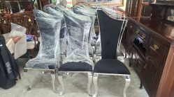 12 Modern design dining chair with a high, curved backrest, black fabric upholstery, and stainless steel frame.