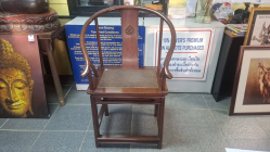 Antique Chinese hardwood horseshoe Huanghuali arm chair with woven rattan seat and carved back splat. Circa late 19th century/early 20th Century.