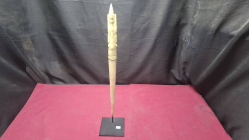 A carved bone Asian buddha figure on metal stand 