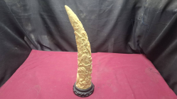A tusk carved with birds and wild animals on stand H.44cm. 