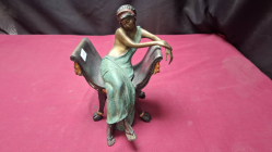 A cold painted bronze seated lady