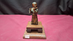 A vintage Japanese figurine on stand of boy playing flute