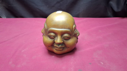A heavy vintage four face brass buddha head marked to base