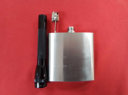 A Stainless steel flask and a small torch