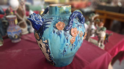 An antique Ming/Qing Shiwan pottery two lug decorated large handled jar with spout (small damage to applied flower decoration).