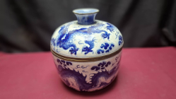 A blue and white porcelain covered jar painted with dragons writhing amidst clouds. H. 23 cm W.22 cm