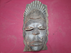 A heavy hand carved wooden African tribal mask detailed facial features and headdresses wall hanging. W.20 cm H.40 cm