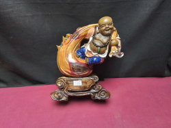 A Vintage mid 20th century Sriwan Kiln pottery laughing Buddha carrying a large bag symboli cally Holds wealth prosperity & good foutune 25cm hight perfect condtion