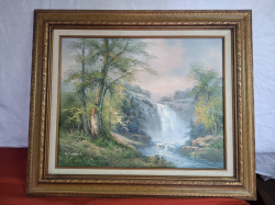 A Good oil on canvas of a waterfall in an oak frame. size 58x68 cm