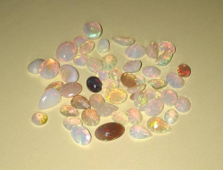 52 Beautiful Solid Crystal Opal stones, 35 faceted and 17 cabachons. Mix of oval, teardrop and round.Lots of colour play.Mix of oval, teardrop and round. Perfect to set in jewellery