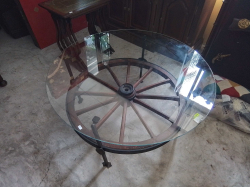A Lovely Glass top coffee table made from a cart-wheel on an iron frame
W94cm.
H47cm.