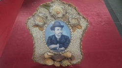 An Old seashells and shell-crafted flowers framed with a portrait that resembles King Chulalongkorn (Rama V) of Thailand. Dimension 27x23 cm