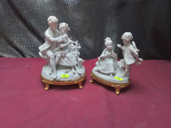 A Pair of bisk figures with Gilt stands H20cm. W13cm.