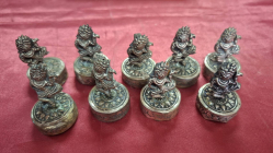 9 Figurines of silver place card holders or menu holders marked The bases of the figurines are stamped with 