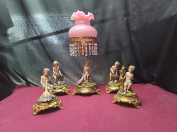 A Lovely Set of 5 porcelain naked Cherubs on brass bases with a pink lamp and light crystal 
H46cm.
W15cm.
