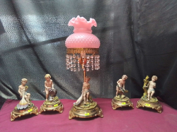 A Lovely Set of 5 porcelain naked Cherubs on brass bases with a pink lamp and light crystal 
H46cm.
W15cm.
