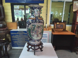A Large Ornate Chinese porcelain floor vase hand painted Gilded around on Wooden craved stand