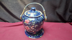 A Biscuit Barrel Blue Pink Roses with Cane handle 
H21cm. W15cm.