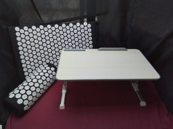 An acupressure mat and pillow and a new bed table 