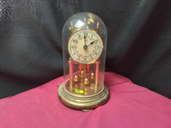 A Gilt battery clock under a dome 
H24cm. W15cm.