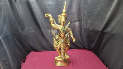 A gold-colored statue of a character in a Thai dance pose. Dimensions 68x25 cm