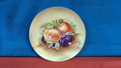An Old vintage porcelain 21 cm diameter hanging plate depicting fruit stamped to back mint condition.