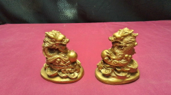 A pair of Chinese gold money dragons with good luck pearl (long bao zhu) sat on a coin base
